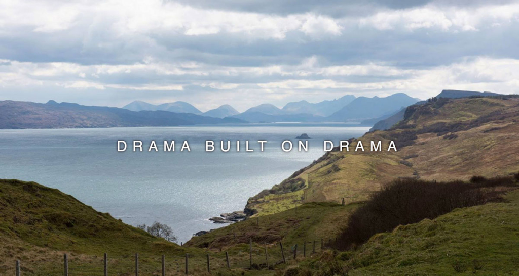 Landscape photograph of a fence and moorland next to a lake with mountains beyond, overlaid with 'Drama Built On Drama' text