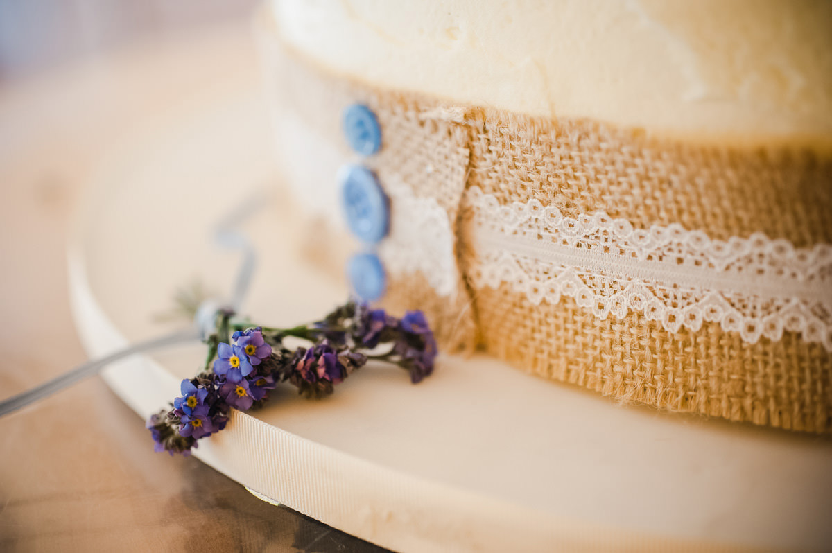 A close up of Forget-Me-Nots at the base of a wedding cake at an Abercairny wedding