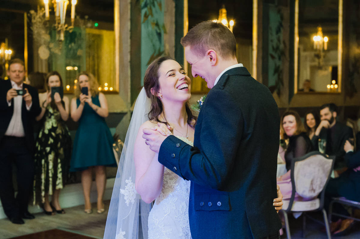 A bride looks lovingly at the groom during their first wedding dance at the Waldorf hotel in Edinburgh